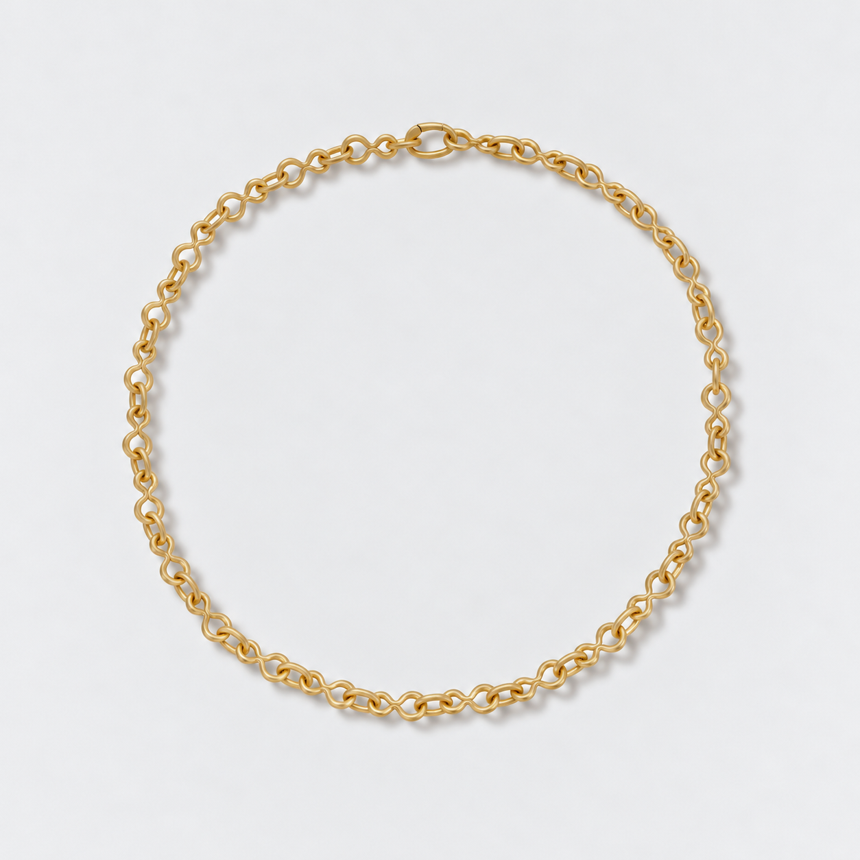 A gold 8 shaped chain necklace with a small lobster clasp, displayed in a neat circle on a light gray background.