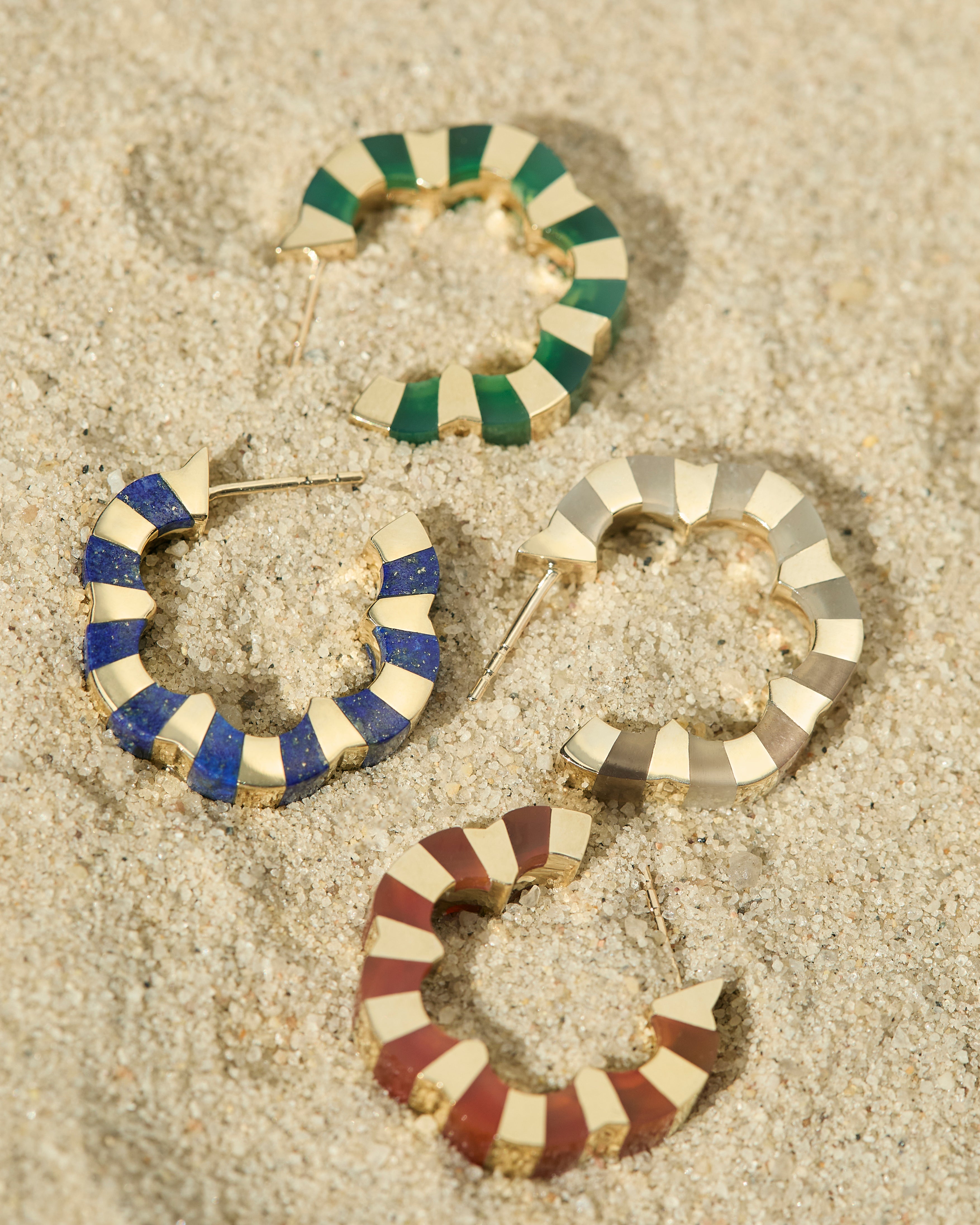 Colorful hoops with carved gemstone crafted in gold designed by Isabel Delgado