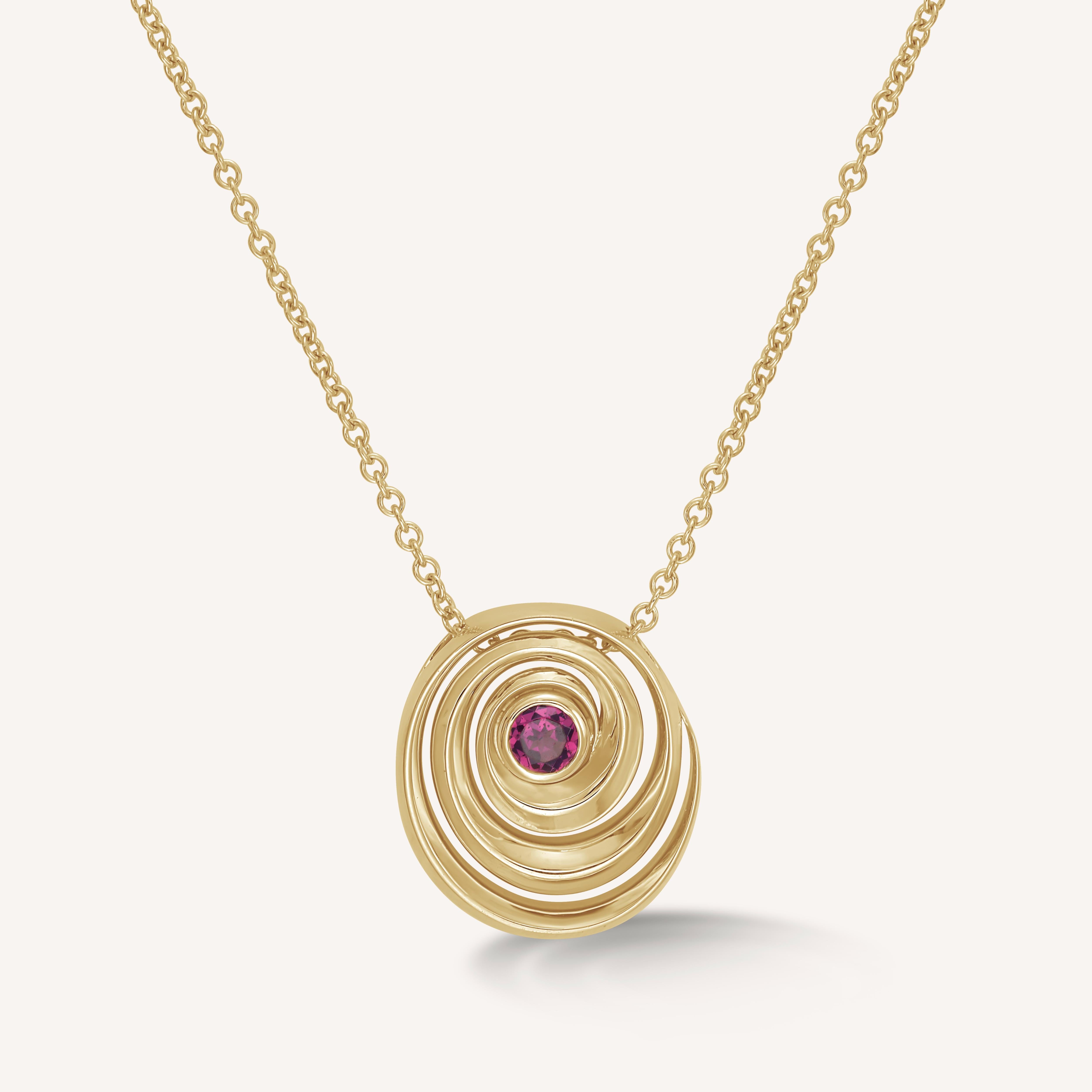 Catalina pendant designed by Isabel Delgado in a shape of a swirl crafted in gold and set with a pink tourmaline