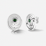 A pair of white gold spiral stud earrings with a small round green gemstone in the center, shown on a light gray background.