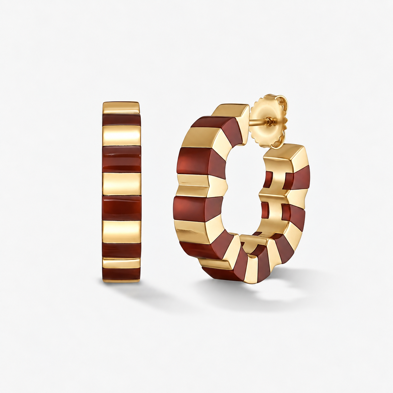 A pair of gold hoop earrings with alternating carnelian and gold striped segments, shown on a clean light gray background.