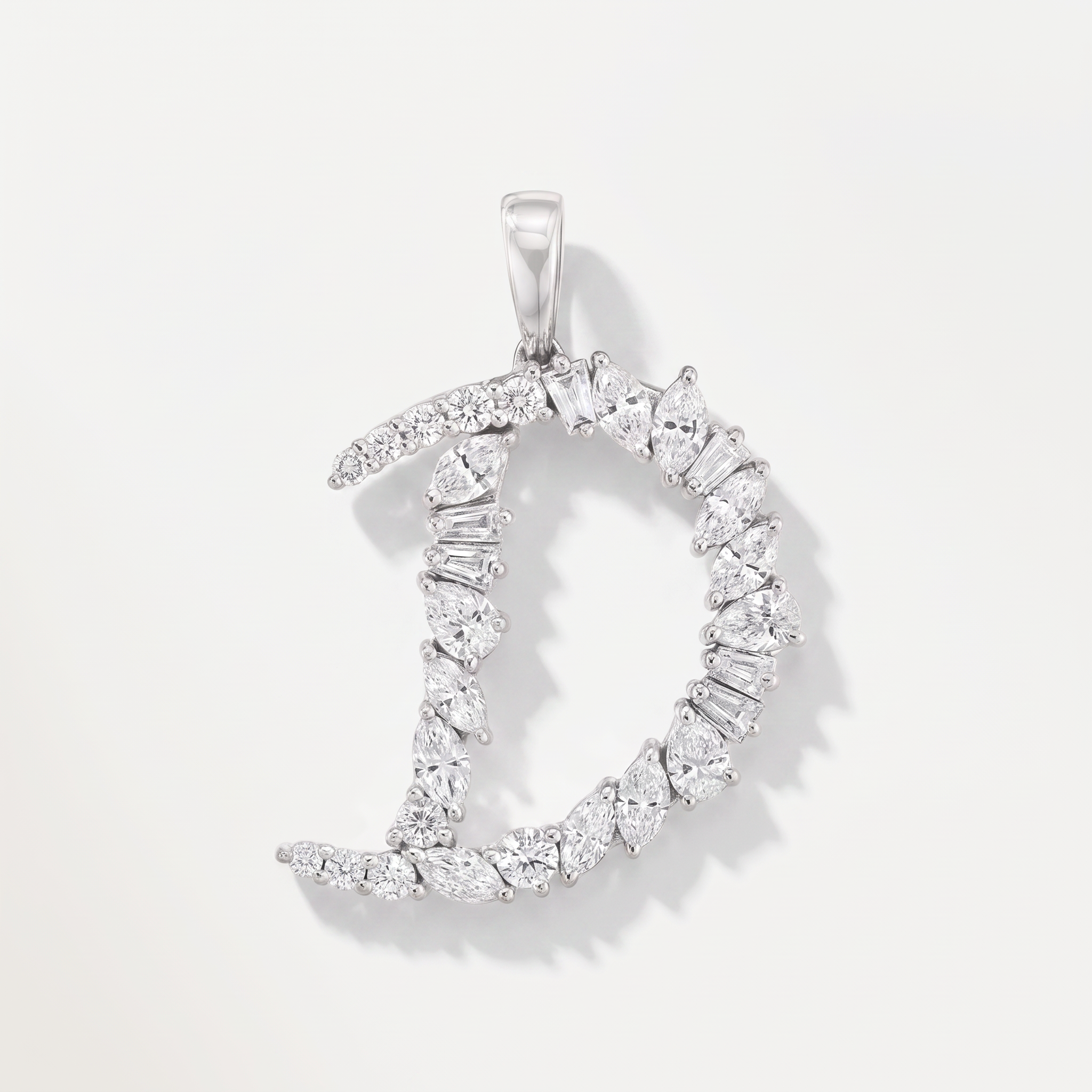 A d shaped diamond pendant made from mixed cut diamonds in white gold