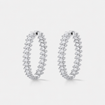 A pair of silver hoop earrings adorned with rows of round-cut diamonds, set against a clean light gray background.