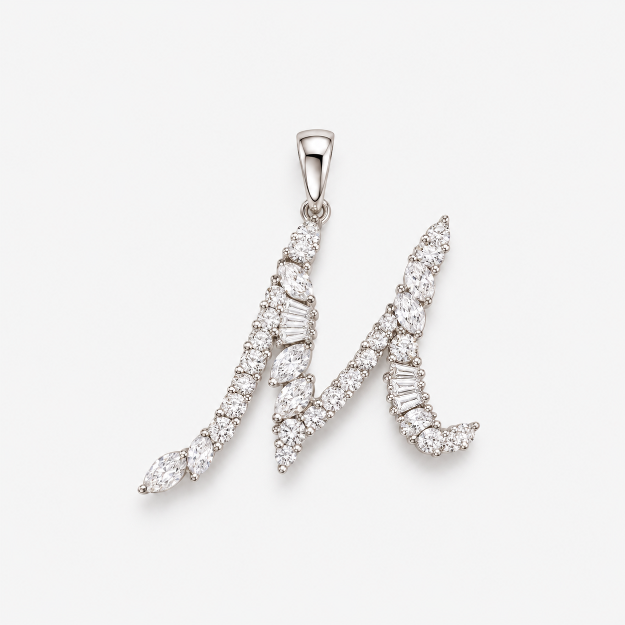 A silver initial pendant 'M' paved with clear marquise and baguette-cut diamonds, shown on a light gray background.