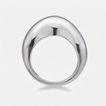 A polished white gold ring with a smooth, rounded teardrop-shaped face, shown on a clean light gray background.