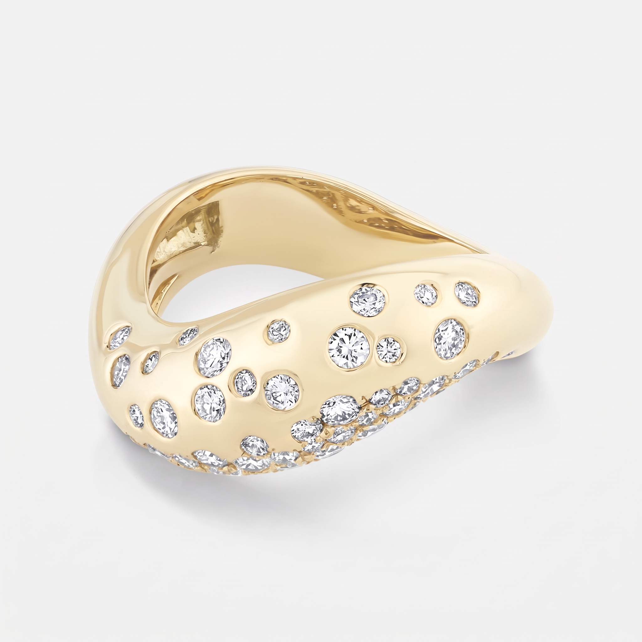 A gold ring with a wavy, organic shape, embellished with small and round clear diamonds, shown on a light gray background.