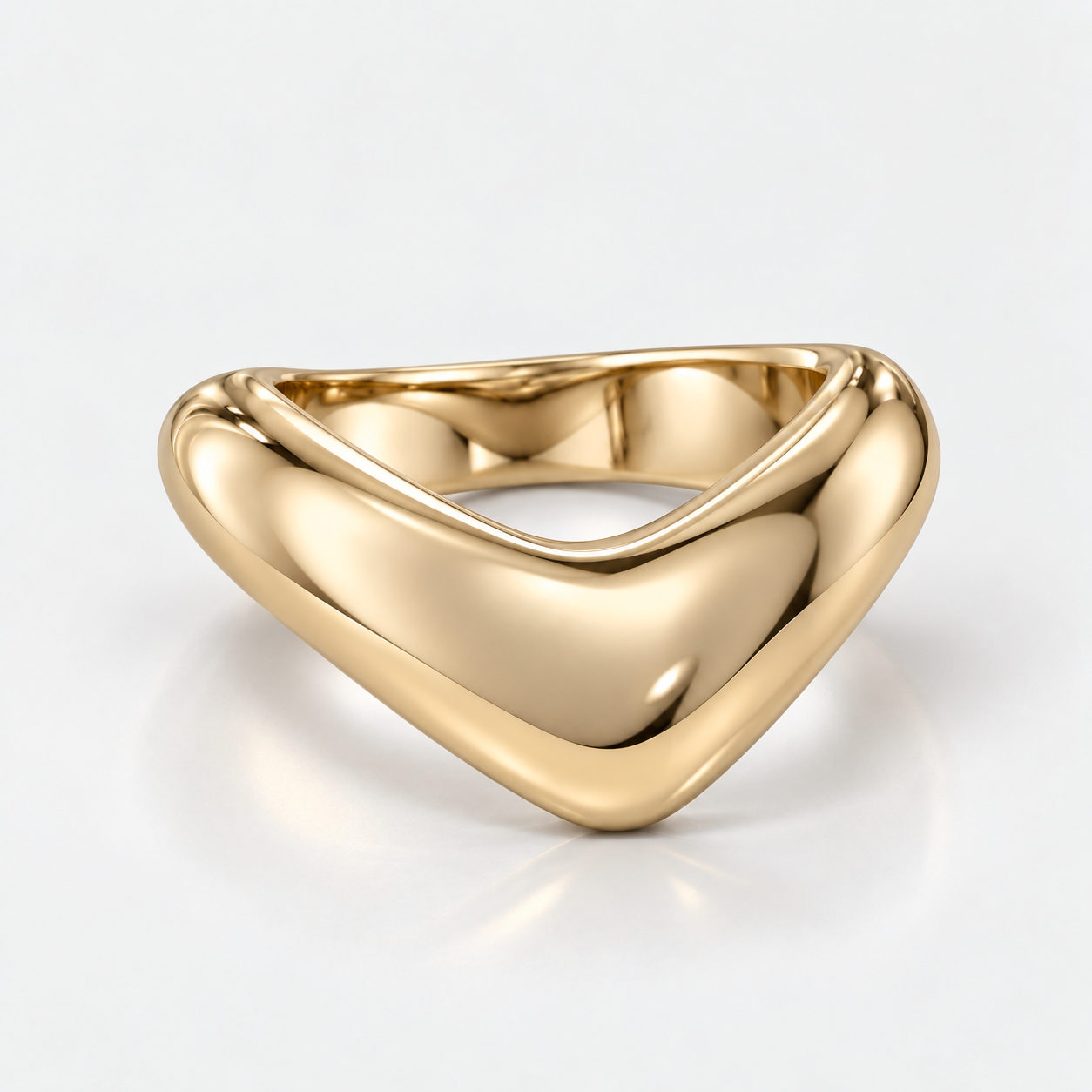 A polished yellow gold triangular ring with a smooth, rounded triangular design, shown on a clean white background with a soft reflection.