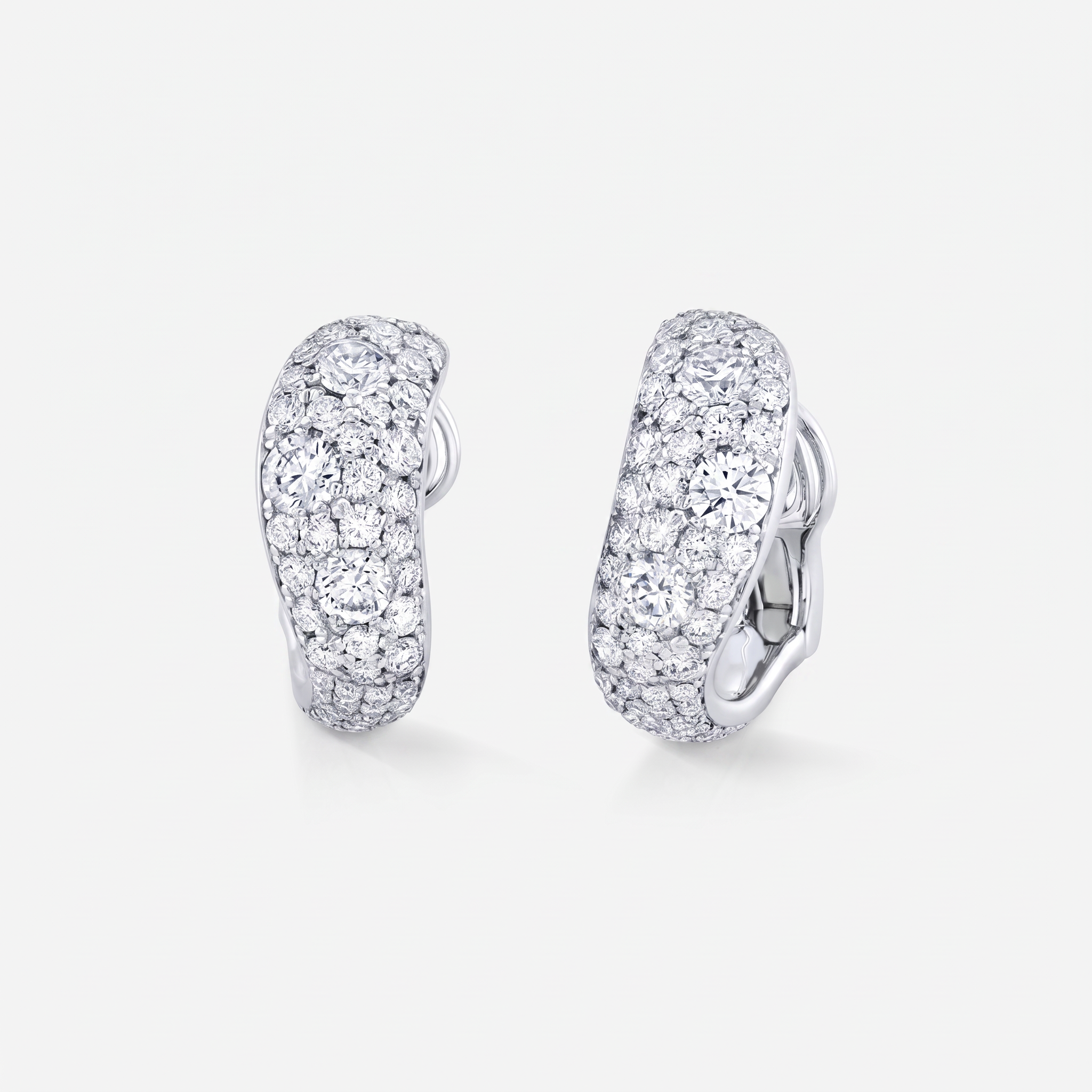Waved shaped diamond huggies with scattered diamonds in different sizes