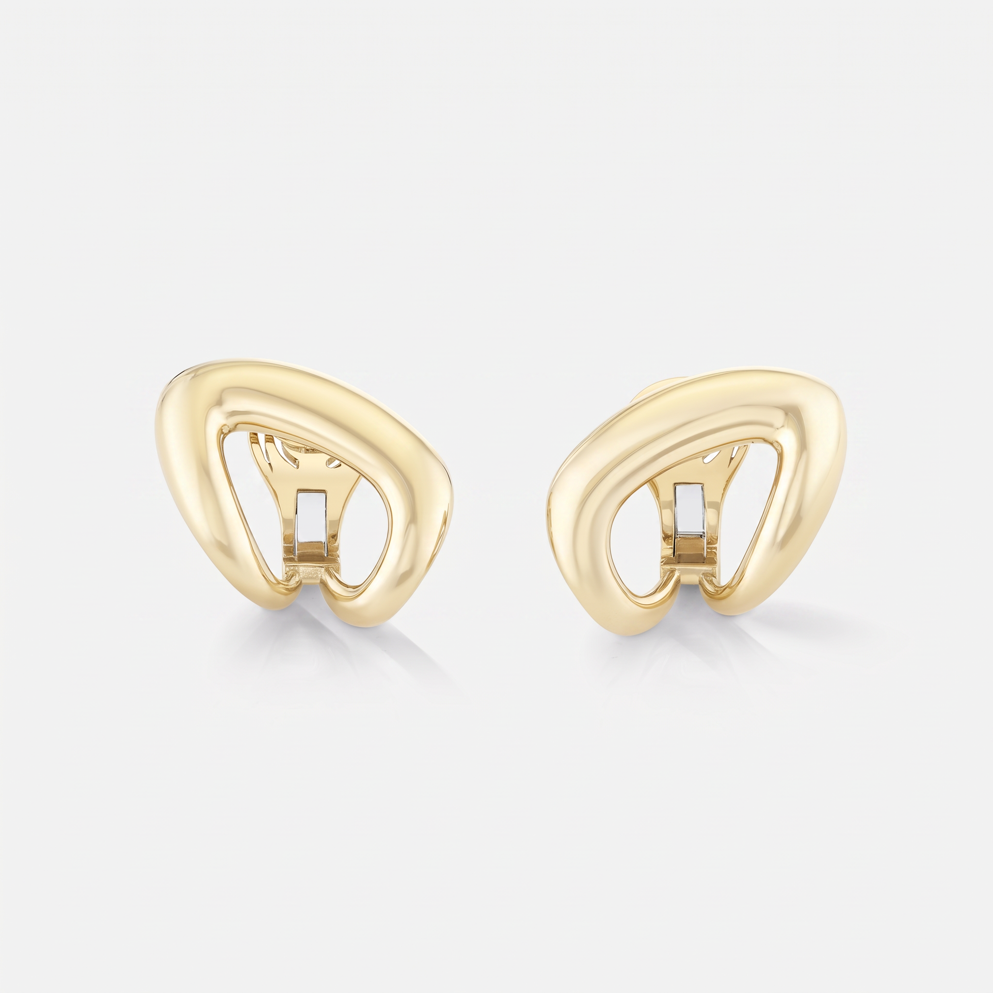A pair of yellow gold abstract designed earrings with a polished, bombe, organic looped style, displayed on a clean white background.