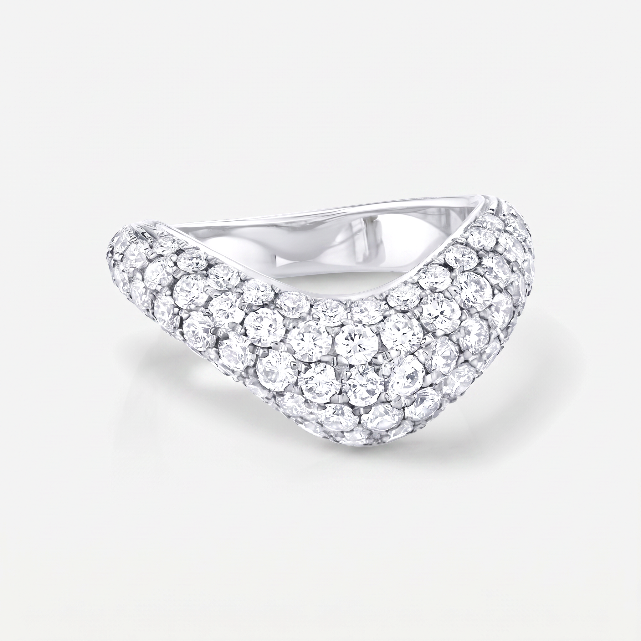 A curved pavé diamond ring in a white gold setting, photographed on a clean light gray background.