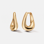 A pair of polished gold huggie hoop earrings with a teardrop-shaped organic design, shown on a clean light gray background.