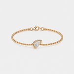 A delicate gold chain bracelet with a small pear-shaped clear gemstone pavé-set in a gold bezel, shown on a light gray background.