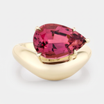 Wave gold ring with a magenta tourmaline pear cut stone set on the curve