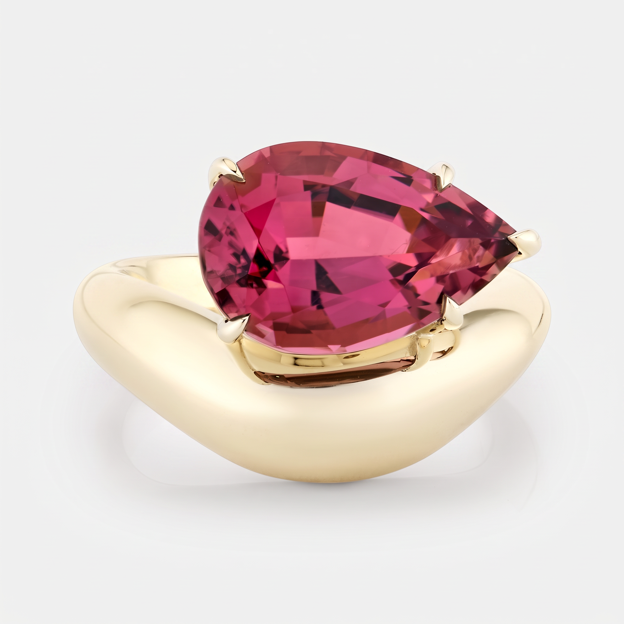 Wave gold ring with a magenta tourmaline pear cut stone set on the curve