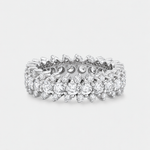 A silver-tone diamond eternity ring with a continuous line of round and cut diamonds, shown on a light gray background.