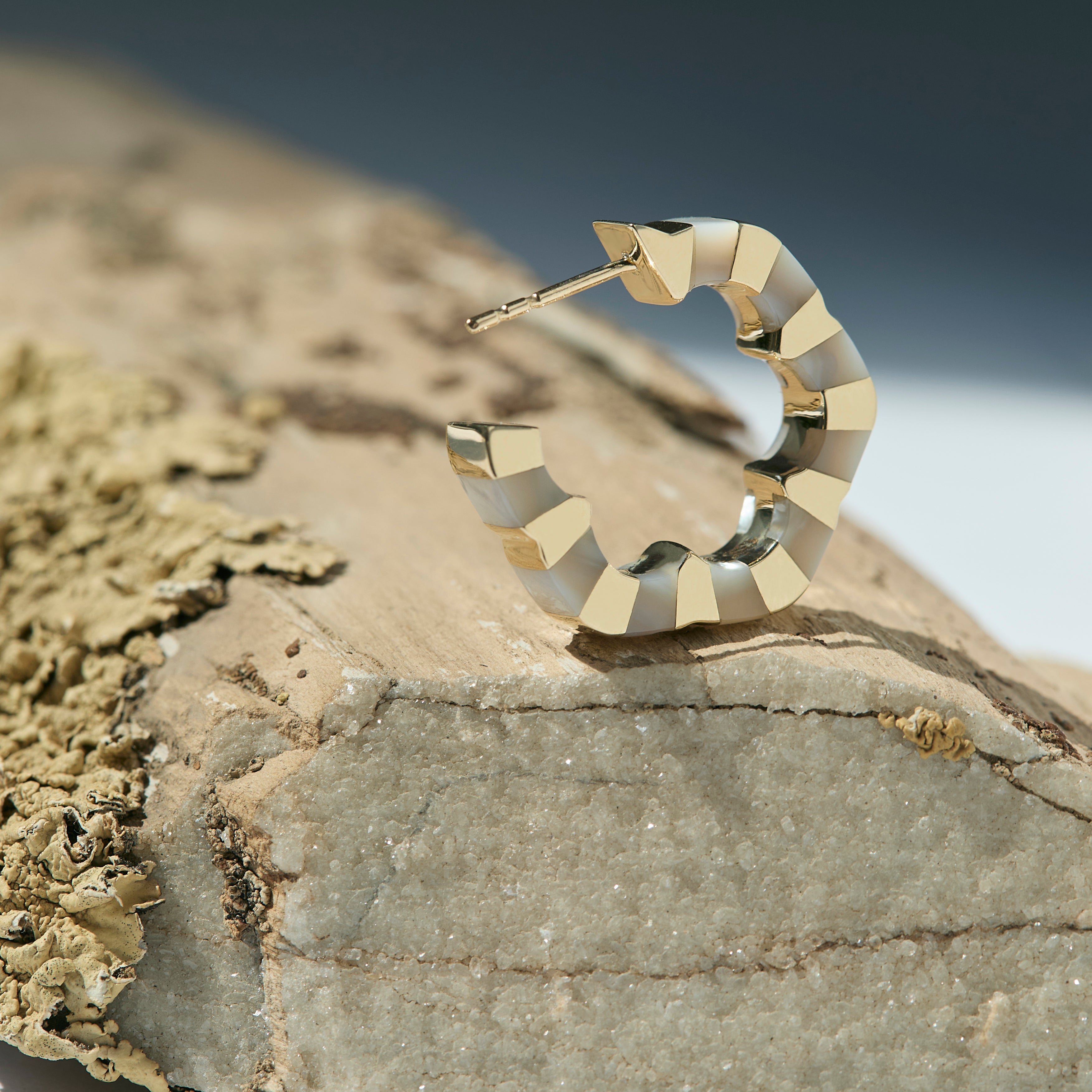 Gold and mother of pearl earrings designed by Isabel Delgado