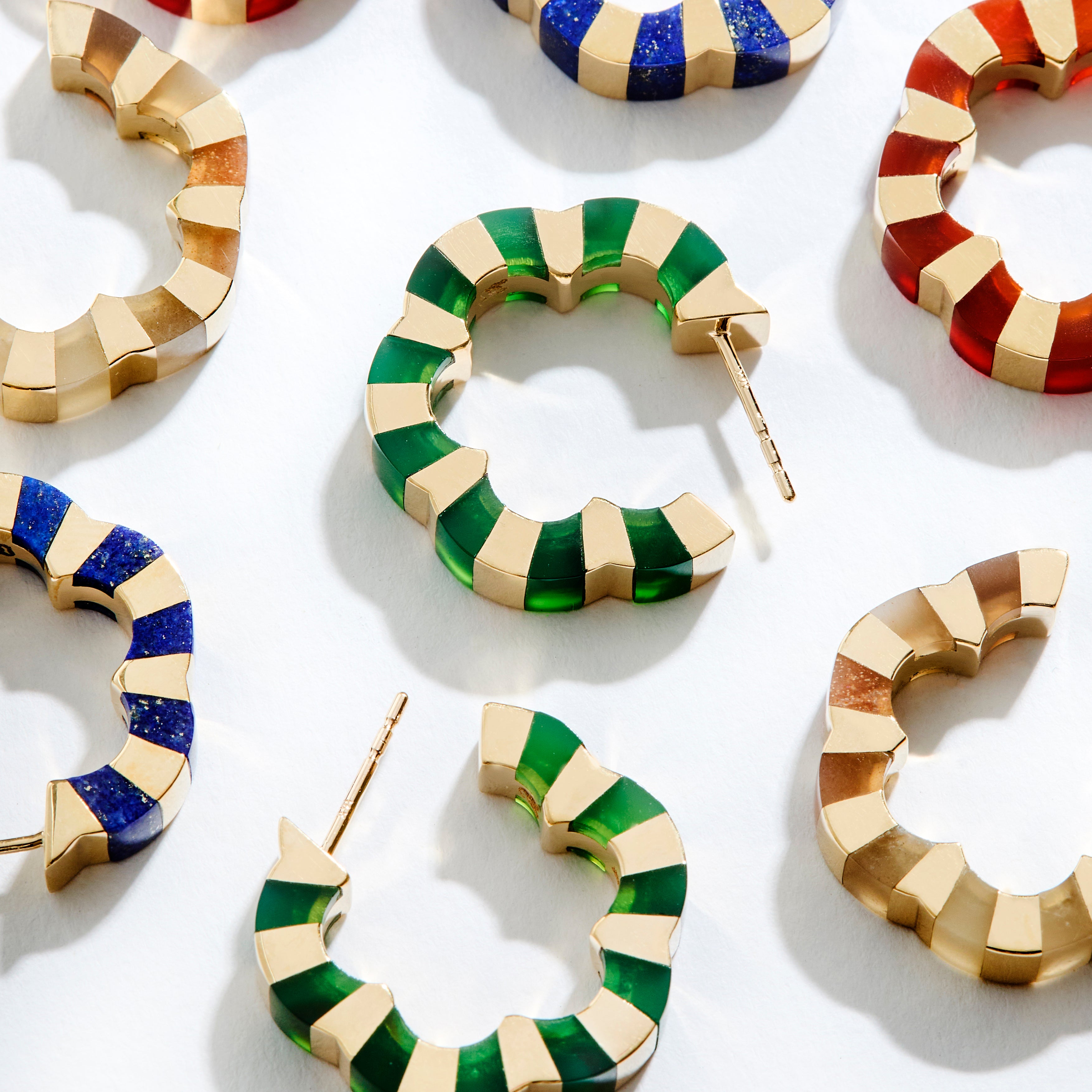 Colorful hoops with carved gemstone crafted in gold designed by Isabel Delgado