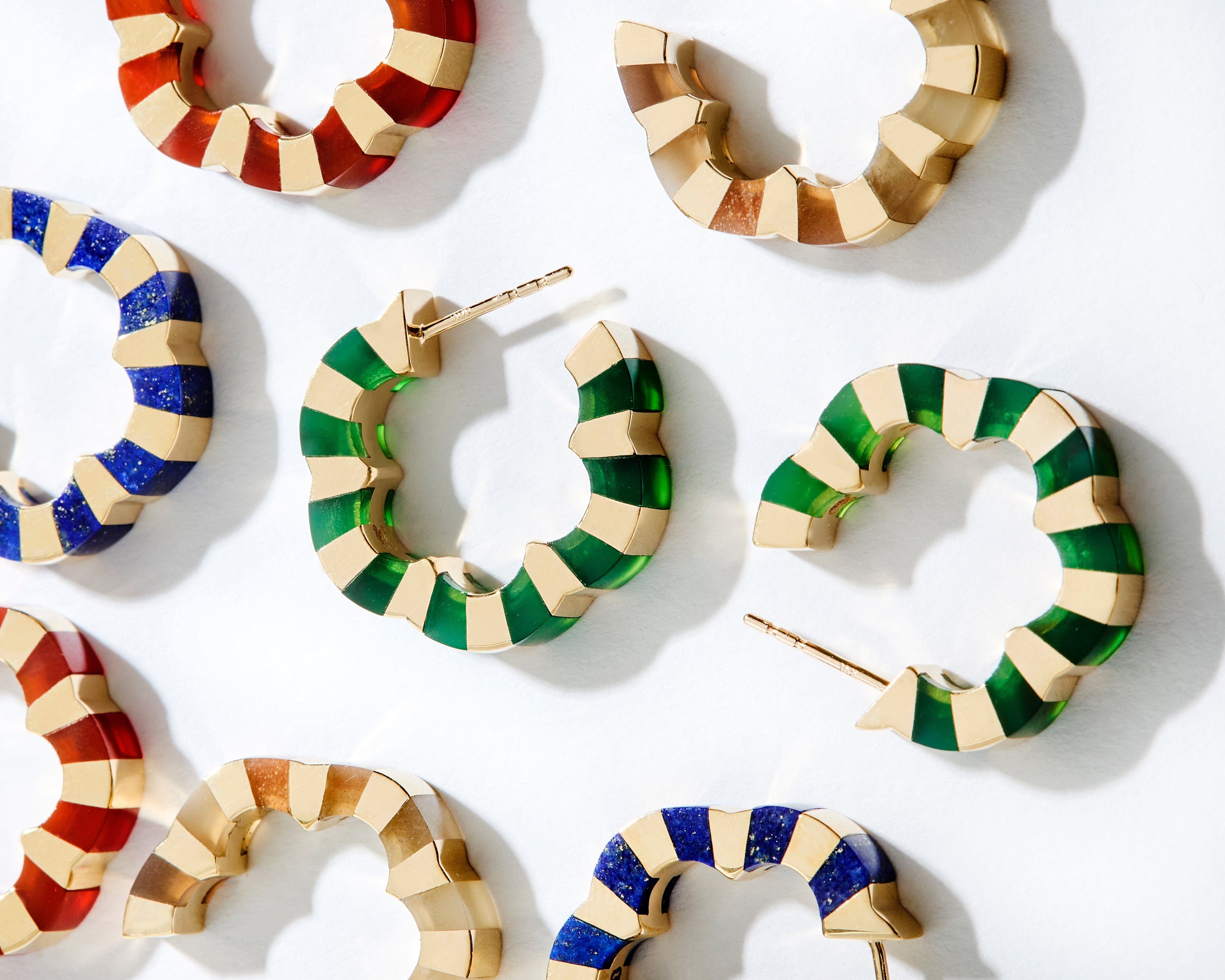 different carved gemstone hoops crafted in gold