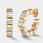 Gold huggie hoop earrings with a segmented design and iridescent mother-of-pearl inlay, shown on a light gray background.