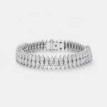 A silver tennis bracelet with rows of pear-cut and round diamonds, displayed on a clean light gray background.