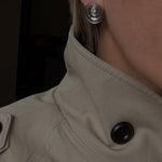 spiral catalina studs that show the dimension of the earrings worn by stylist