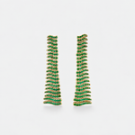 A pair of gold-toned drop earrings paved with small green emeralds in a layered, wavy spiral pattern, set against a plain light gray background.