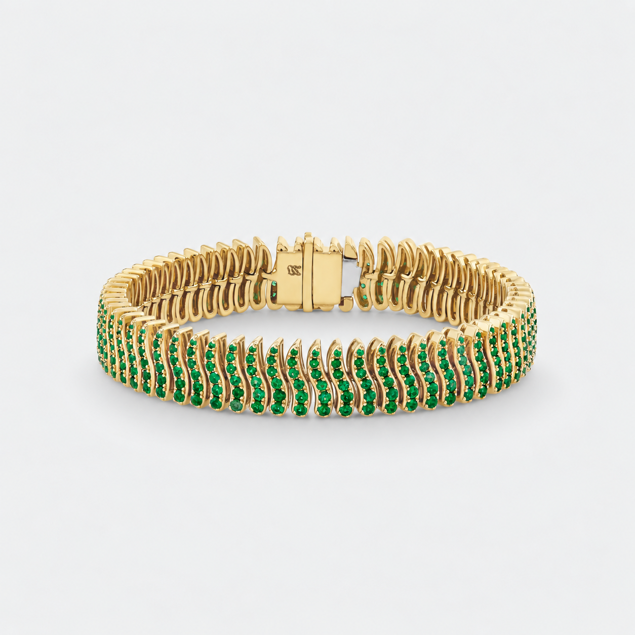 A yellow gold tennis bracelet featuring rows of round-cut green emerald-cut gemstones, displayed on a clean light gray background.