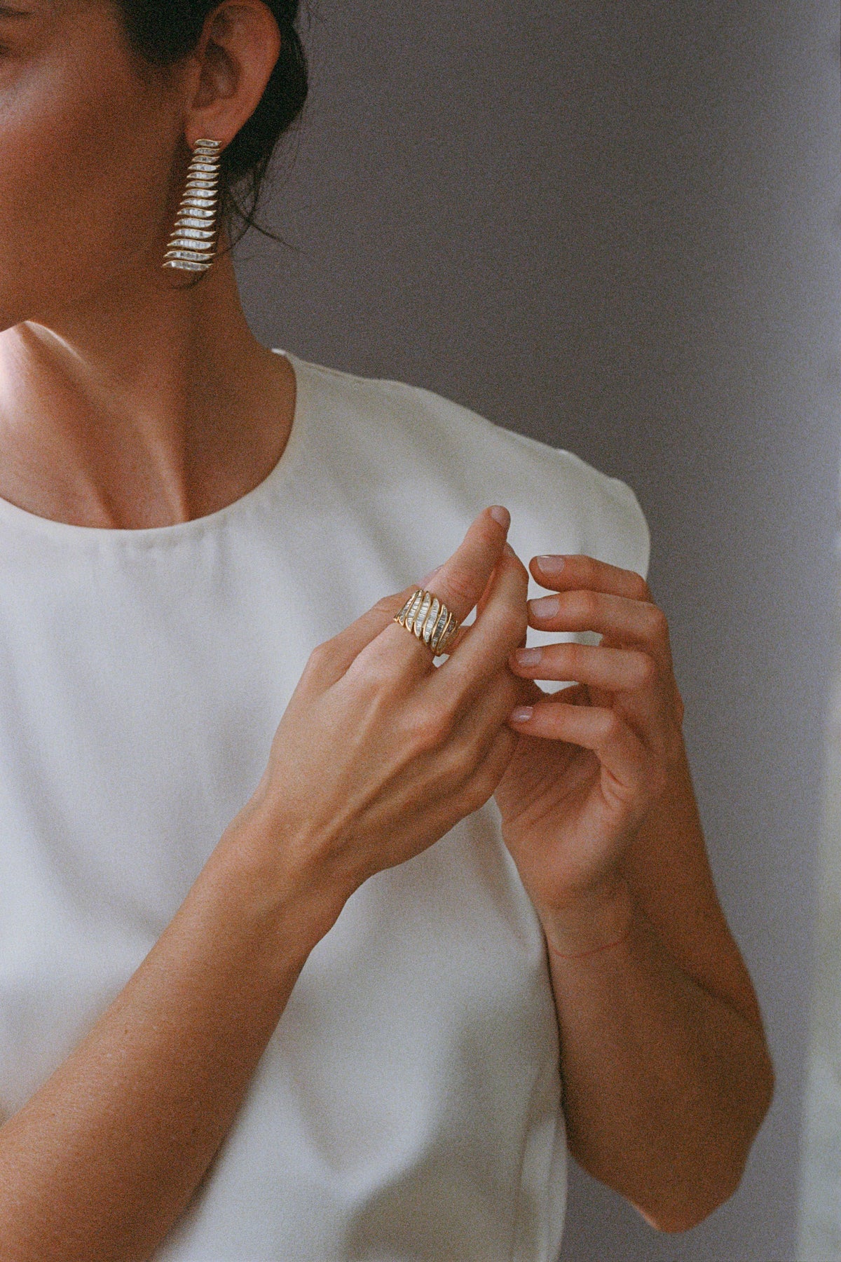 Model wearing baguette diamond earrings and baguette diamond ring