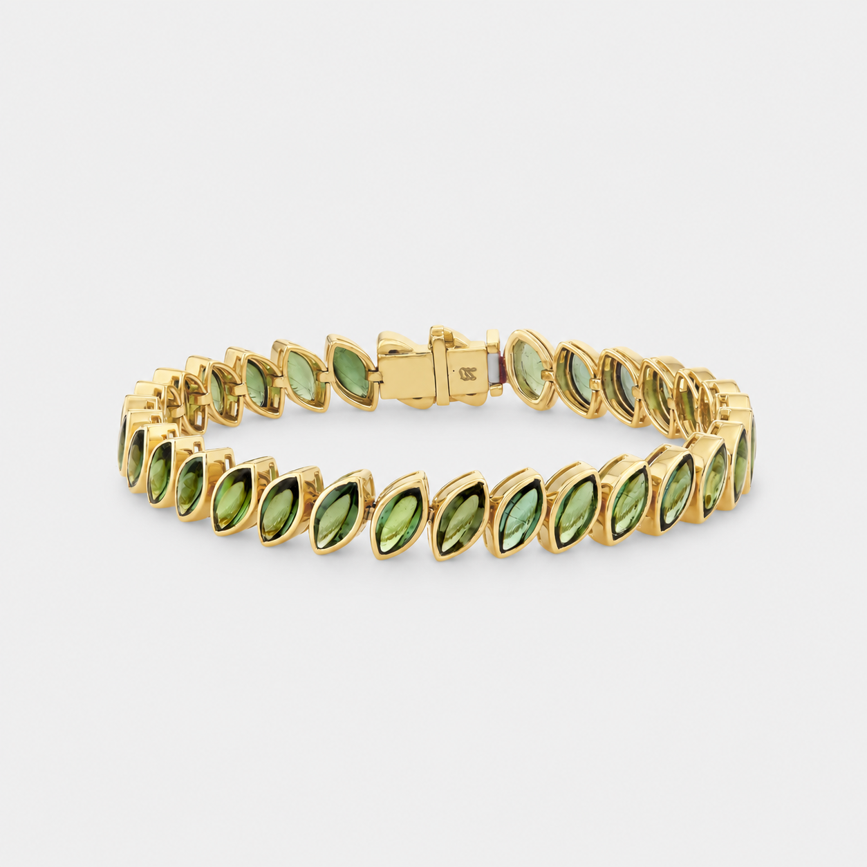 A gold tennis bracelet featuring marquise-cut green tourmalines, displayed on a clean light gray background.