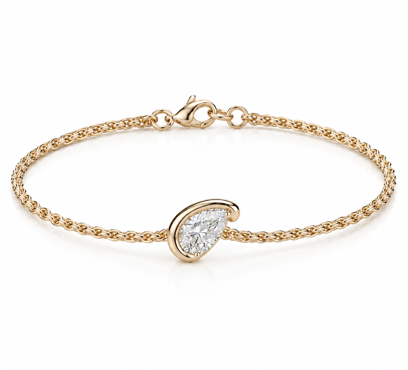 A delicate yellow gold chain bracelet with a pear-cut clear gemstone in a gold bezel setting, displayed on a clean white background.