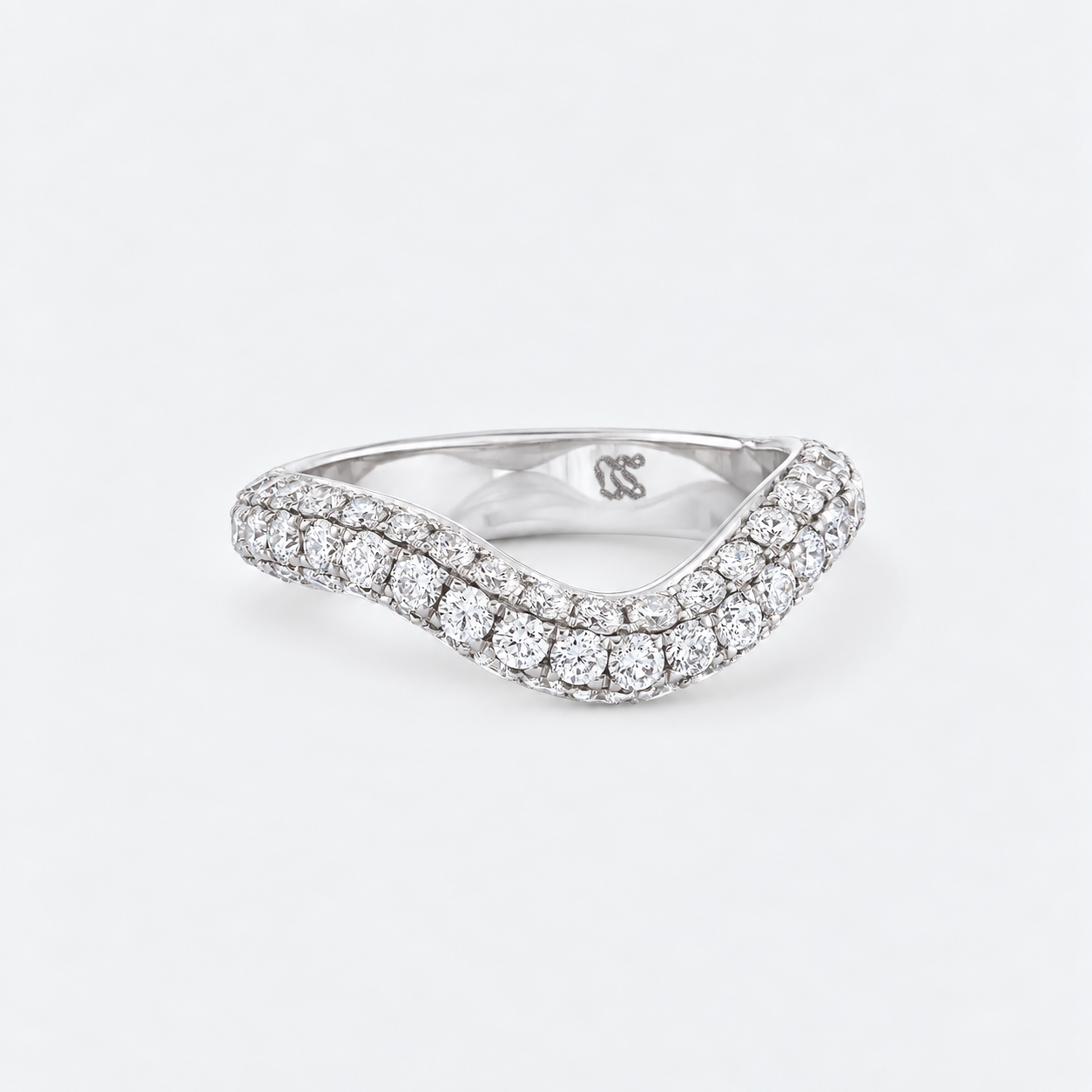 A silver wavy band ring paved with round diamonds, shown on a clean white background. The inside of the band features a small 'RS' logo engraving.