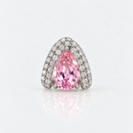 A pear-cut pink gemstone ring set in a silver-toned pavé band, photographed on a clean white reflective surface.