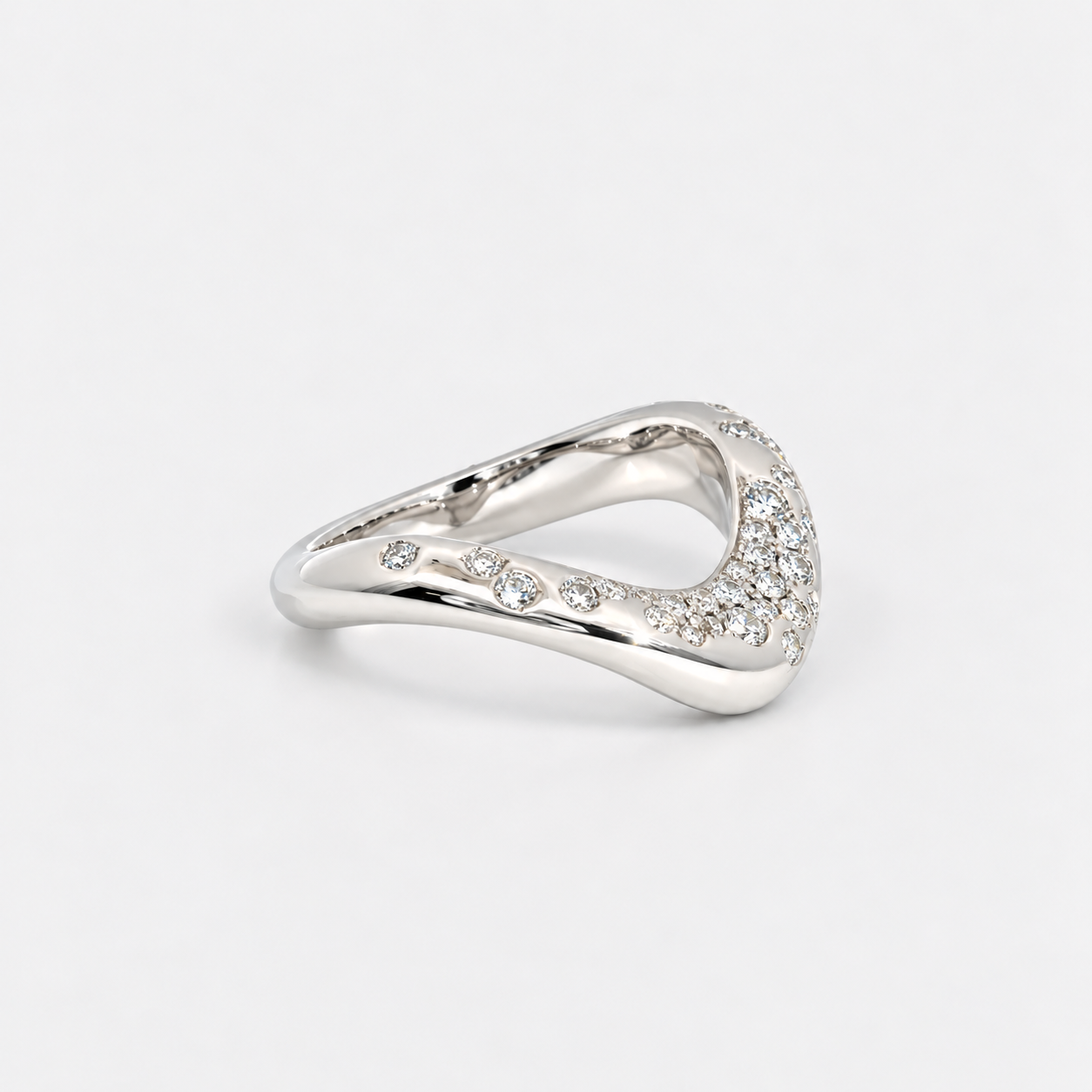 A silver-toned wavy ring with pavé-set clear stones along the front curve, photographed on a clean light gray background.