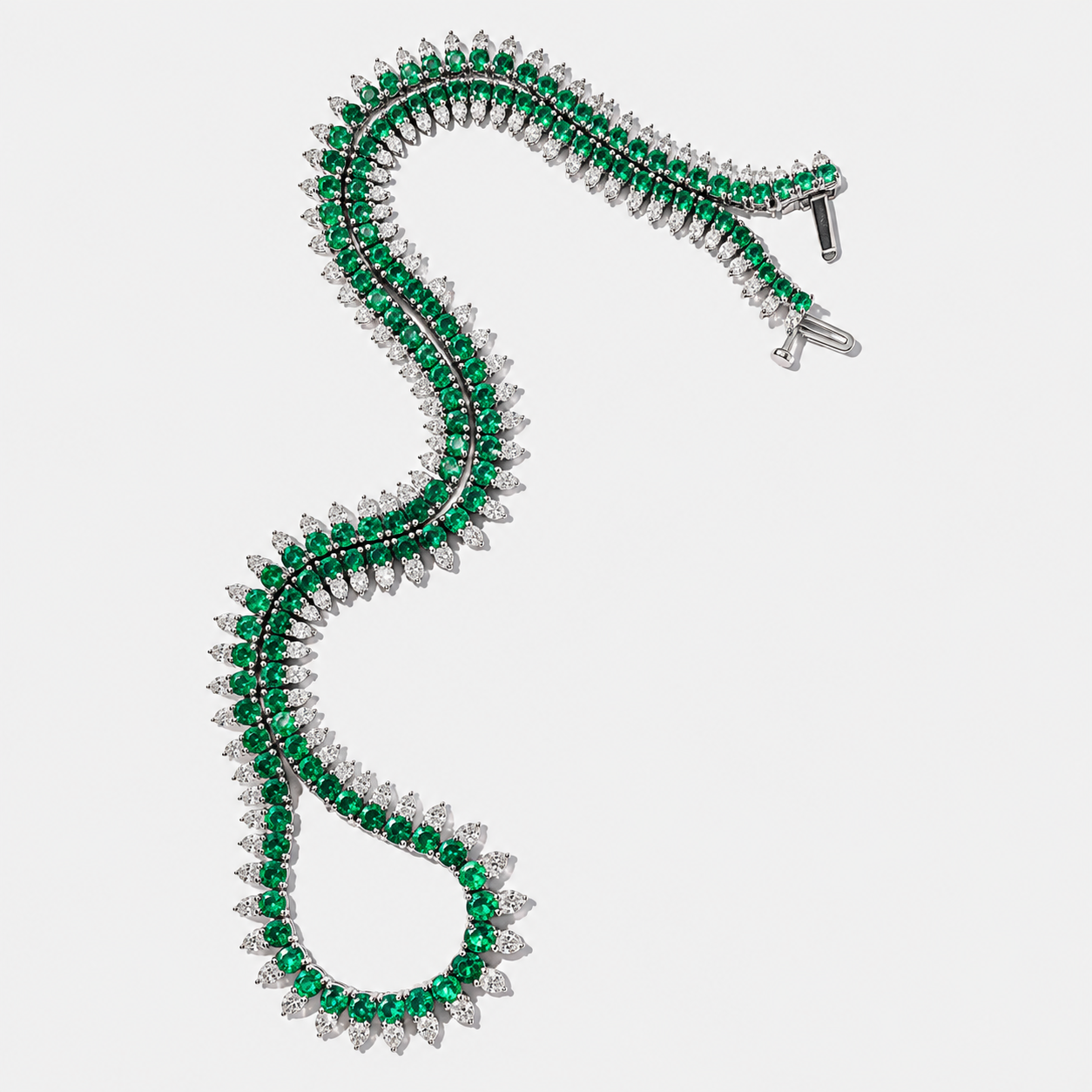a white gold emerald necklace with diamonds underneath