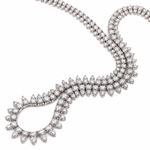 A white-tone diamond necklace featuring a round-shaped openwork center with rows of clear stones, connected to a double-strand chain, shown on a plain white background.