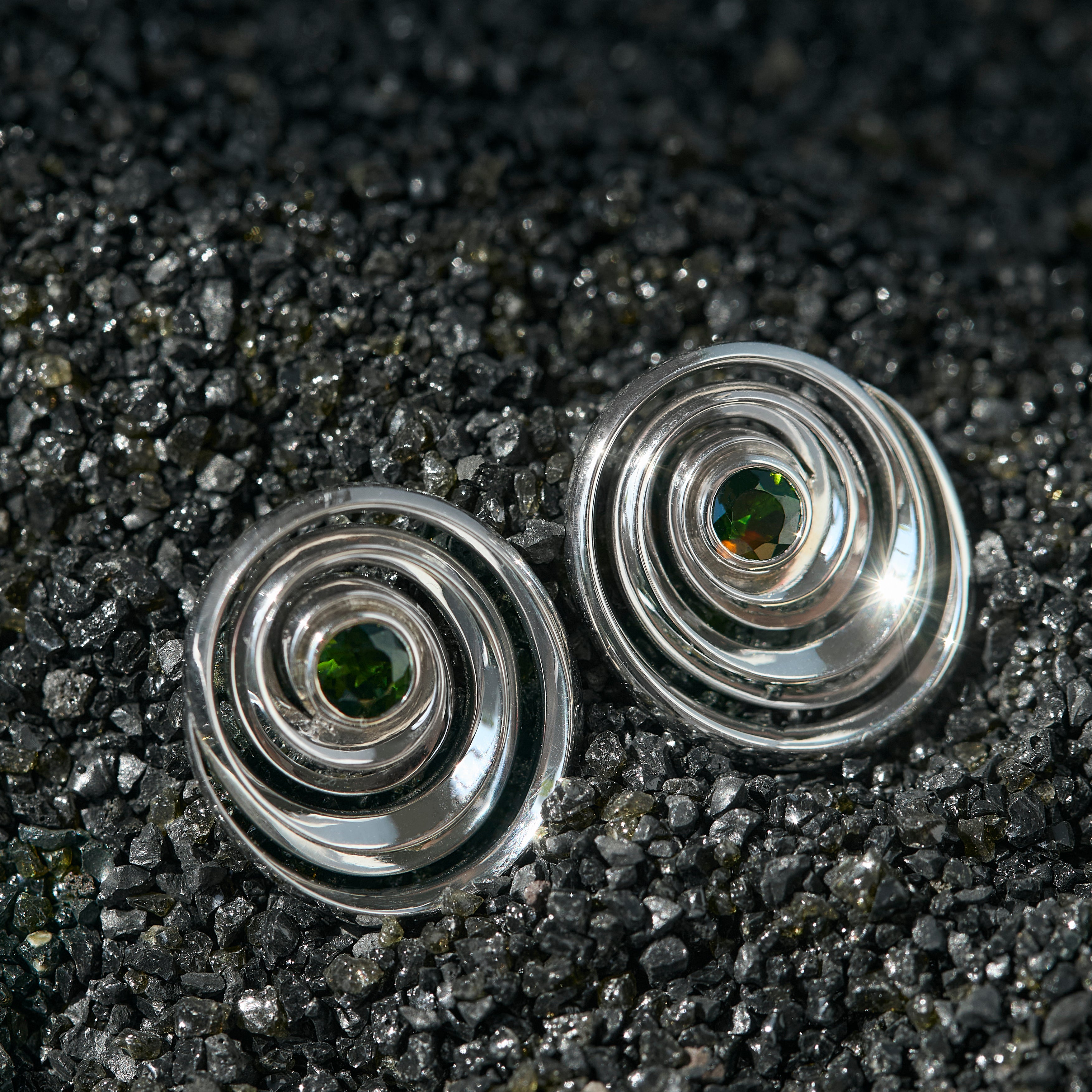 Studs in the shape of a spiral set with green tourmalines