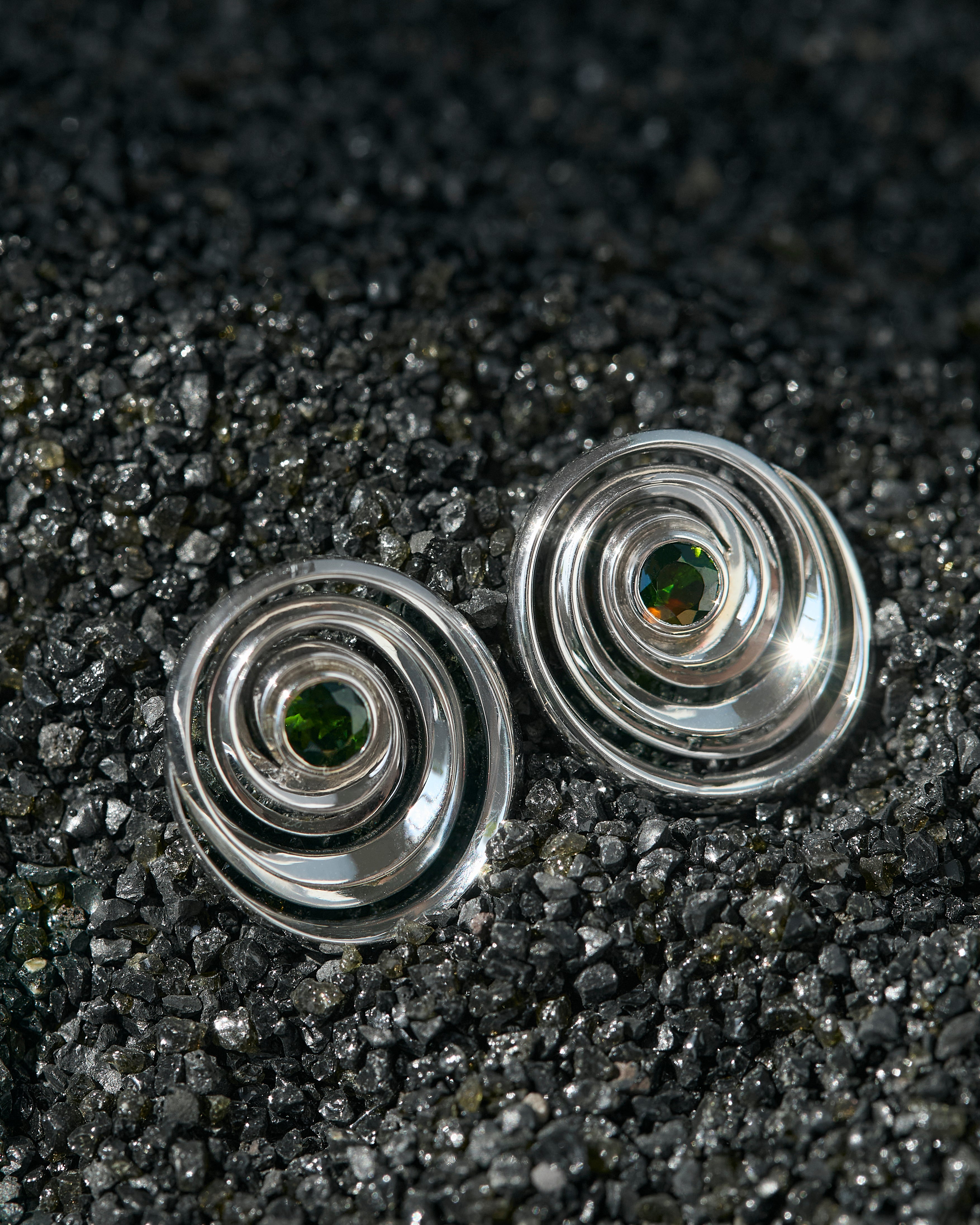Studs in the shape of a spiral set with green tourmalines