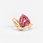 A yellow gold ring featuring a large, faceted pink triangular gemstone in a prong setting, displayed on a clean white background.